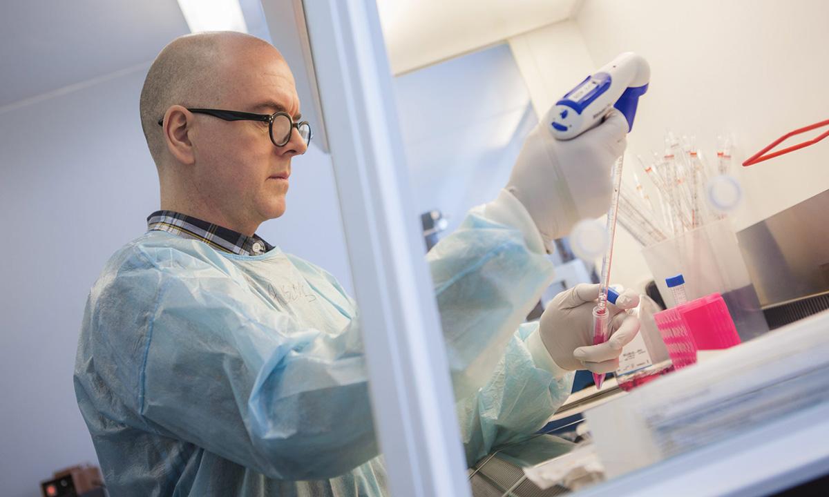 Dr Michael Jarvis, The Vaccine Group Michael Jarvis in plastic gown pipetting